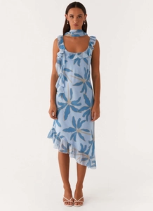 Detail of light blue sleeveless dress featuring ruffle trim and asymmetrical chiffon hem