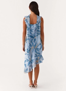 Back view of floral chiffon dress showing ruffle straps and asymmetrical hem detail