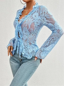 Close-up of light blue sheer floral lace fabric and delicate ruffle details on the sleeve