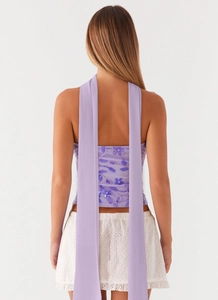 Detailed back view of purple floral sequin embroidery top with long flowing ribbons