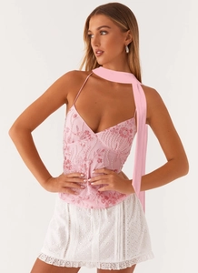 Detail of pink sequin camisole with floral embroidery and matching neck scarf decor