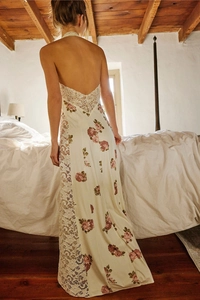 Detail of floral backless halter maxi dress with delicate lace patchwork and silk texture