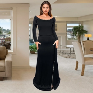 Elegant black off-shoulder evening dress with long sleeves and sequined side slit detail