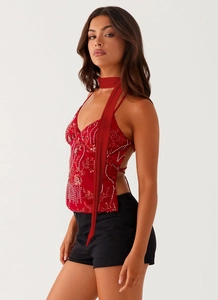 Detail of red sequined halter top with matching neck scarf and floral beadwork embroidery