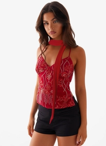 Detail of red sequin floral camisole top with V-neck and silver beaded fringe hem