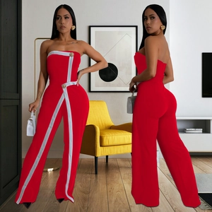 Red strapless jumpsuit with white trim and gold buttons in a wide-leg cut style