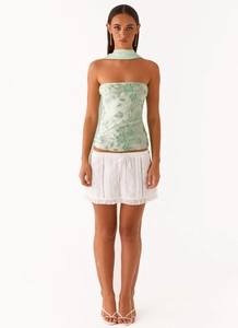 Detail of light green floral sequin embroidery on top with matching scarf and white skirt