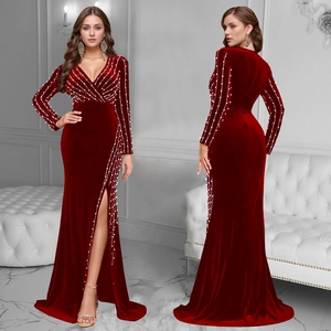 Detail of burgundy velvet dress with deep V-neck, high slit and white pearl embellishments