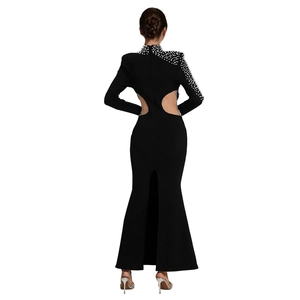 Detail of elegant black slim-fit dress featuring back cut-outs and white pearl embellishments