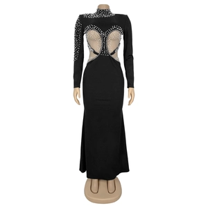 Detail of elegant black dress with pearl beads and mesh neckline on a mannequin