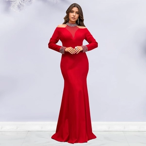 Close-up of elegant red evening dress featuring rhinestone embellishments on the neckline
