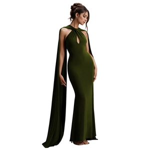 Detail of dark green evening gown featuring a keyhole neckline and elegant shoulder capes