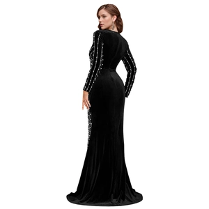Detailed view of luxury black velvet dress with white beadwork and high side slit design