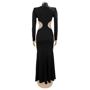 Detail of elegant black evening gown back with pearl beads and side mesh cutouts