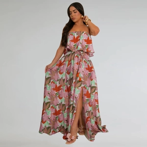Detail of high-waist maxi skirt with vibrant floral print and orange tassel drawstring