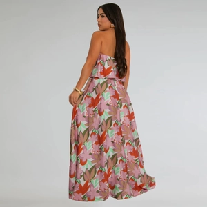 Side view of floral print maxi dress featuring a high slit and colorful flower patterns