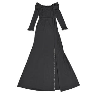 Detail of elegant black evening dress showing pearl-embellished bow neckline and side slit