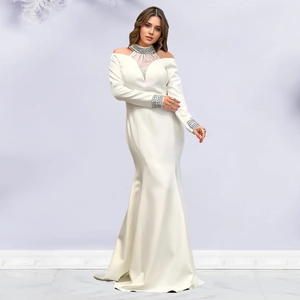 Detail of elegant white mermaid dress with rhinestone collar and long sleeves for gala