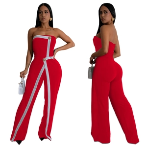 Detail of red strapless jumpsuit featuring white V-trim and gold decorative buttons