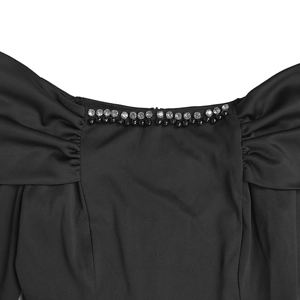 Detail of elegant neckline with rhinestone and bead embellishments on black dress