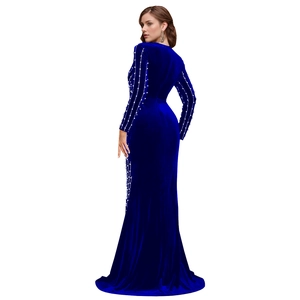 Detail of royal blue velvet dress with elegant pearl embellishments on the long sleeves