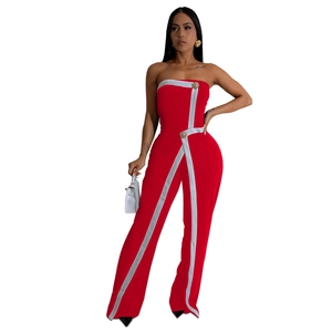 Detail of red strapless jumpsuit with white Y-shaped stripes and gold button accents