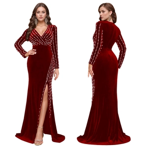 Detailed close-up of wine red velvet evening dress featuring pearl bead embellishments