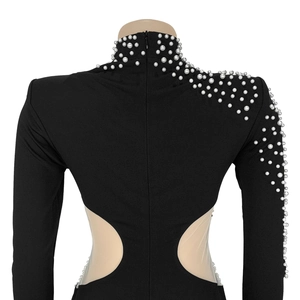 Detail view of black dress featuring pearls on high neck and sheer mesh side cutouts