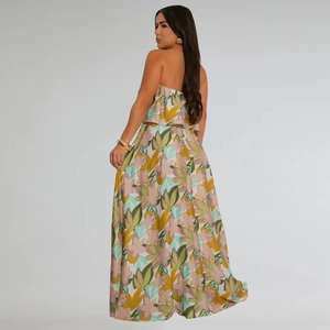 Detailed back view of sleeveless floral maxi dress featuring tiered ruffles and side slit