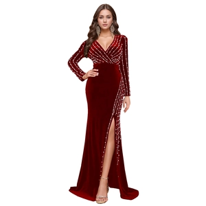 Detailed close-up of velvet gown featuring radiant white beadwork and sparkling rhinestones