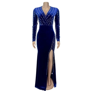 Detailed view of royal blue velvet dress featuring elegant pearl beadwork and high side slit