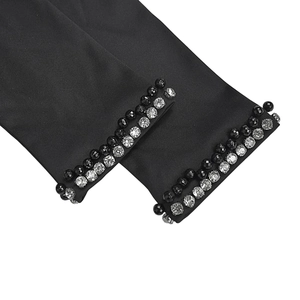 Detail of elegant black satin long gloves featuring exquisite beaded trim and pearls