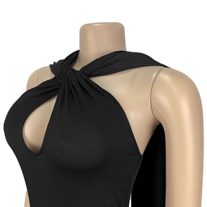 Detail of twist halter neckline with keyhole cutout on elegant black dress fabric