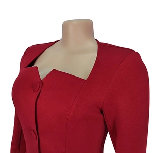 Detail of red V-neck office dress with asymmetric neckline and fabric-covered buttons