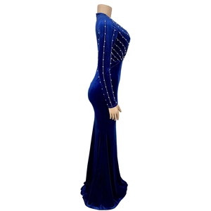 Detail view of deep blue velvet dress with long sleeves and vertical pearl embellishments