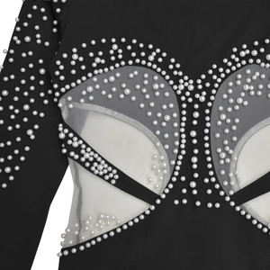 Detailed view of hand-beaded white pearls on black sheer mesh long sleeve dress