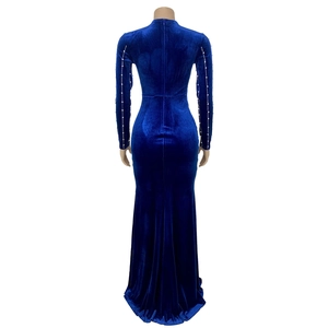 Rear view of velvet evening dress with rhinestone details on sleeves and fishtail hem