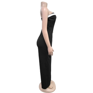 Side view of bodycon strapless jumpsuit featuring black and white contrast trim detail