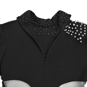 Detail of high neck black dress featuring white pearls and silver rhinestone embellishments