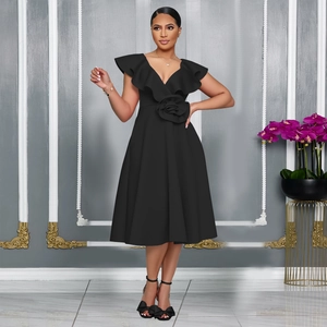 Detail of elegant black V-neck dress featuring ruffled neckline and 3D floral waist decoration