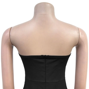 Detail view of the back of a black strapless romper with hidden zipper on elastic fabric