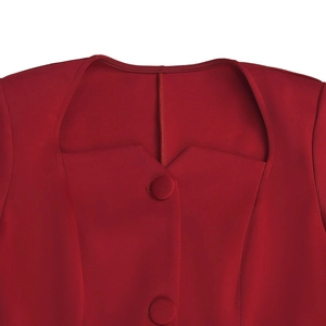 Detail of red dress showing square neckline with V-notch and fabric covered buttons