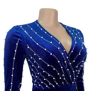 Detail of royal blue velvet dress with sparkling rhinestones and pearl embellishments
