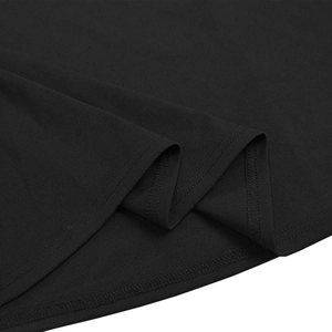 Close-up of black knit fabric detail with double-needle stitching on the dress hemline