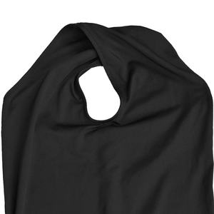 Close-up of circular cutout detail and stitching on an elegant black solid dress