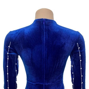 Detail of blue velvet dress featuring purple hidden zipper and pearl beaded sleeve trim