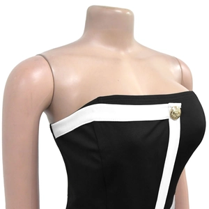 Close-up of contrast color tube top jumpsuit featuring a gold lion emblem button