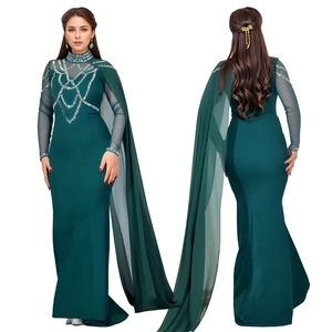 Détail d'une robe élégante vert foncé avec motifs en strass argentés et cape en mousseline