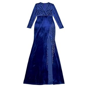 Detailed view of royal blue velvet dress featuring silver beadwork and high slit design