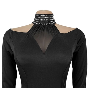 Detail of high neck black dress with four rows of silver rhinestones and mesh insert